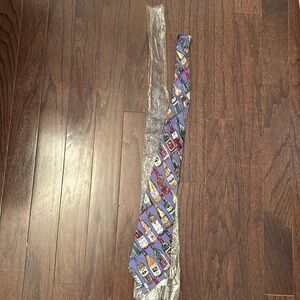 Nicole Miller 100% silk tie. Blue with wine bottle pattern.
